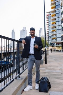 Young businessman using smartphone in city outdoor