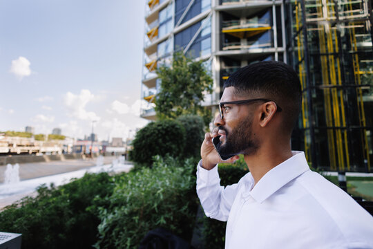 Young businessman talking on smartphone in urban city