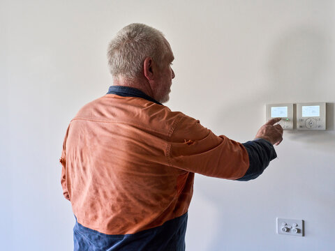 Aircon Technician Changing Program During Aircon Service