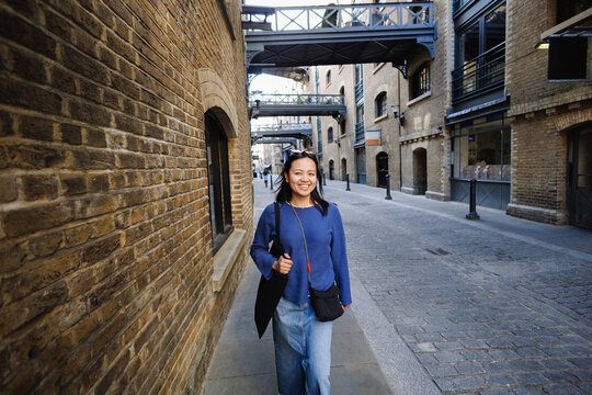 Filipina woman smiling walking in Shad Thames, London