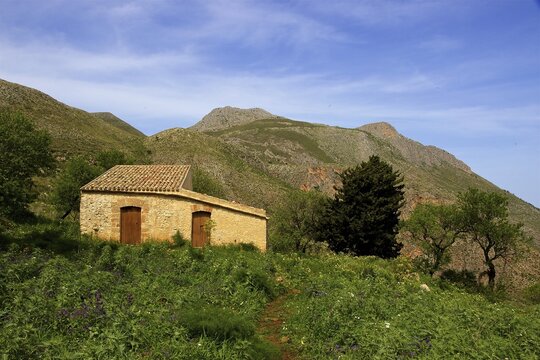 Green meadow, mountains, stone house, tiled roof, Zingaro, national park, nature reserve, northwest, Sicily, Italy