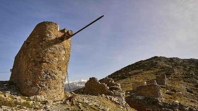 Old windmill, flour mill, windmill ruins, snow-capped mountains, Ambelos Pass, blue sky, Lassithi plateau, Lassithi, East Crete, island of Crete, Greece