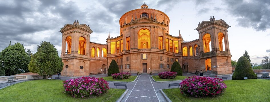 Illuminated Santuario Madonna di San Luca church on the hills of Colle della Guardia, in the evening, Bologna, Emilia Romagna, Italy
