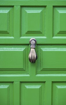 Door knocker in the shape of a hand on a green door, Teguise, Lanzarote, Canary Islands, Spain