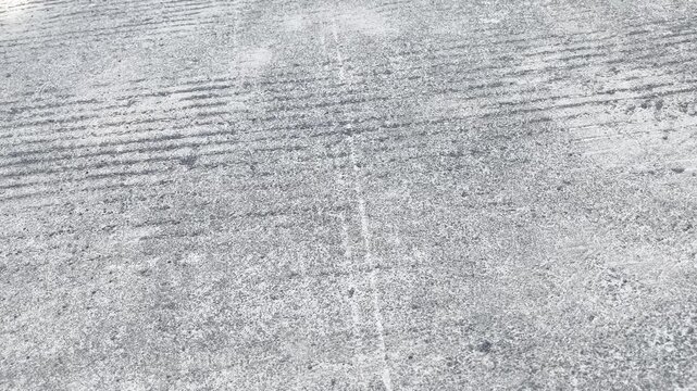 Minimalist concrete highway surface with linear pattern during daytime