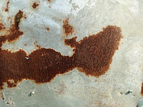 Rusted metal texture background with brown corrosion on weathered zinc steel sheet surface for abstract vintage industrial design
