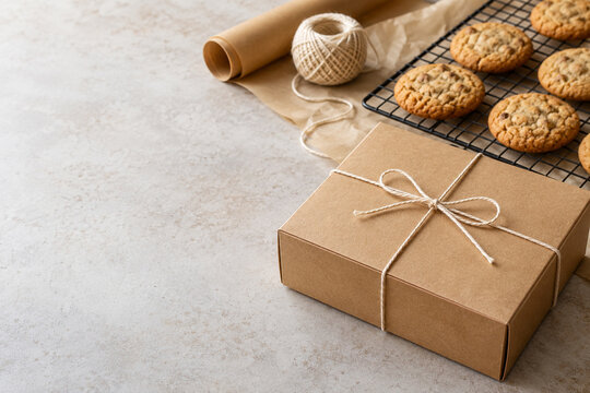 Kraft pastry box with twine beside cookies and cooling rack