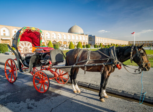 Side view of a Horsedrawn carriage by the Imam Khomeini Mosque, Naghsh-i Jahan Square, Isfahan, Iran