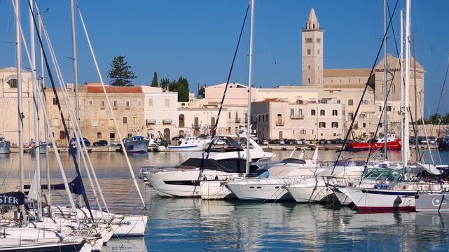 Trani Marina Puglia Italy Yacht Harbor View Trani Cathedral Masts Framing Right to Left Pan Wide Angle Luxury Boats Seaport Adriatic Coastline Travel B Roll 4K UHD Video