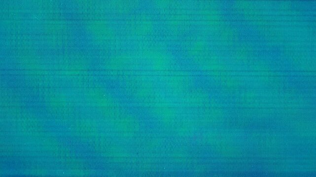 Macro teal and blue glitch noise on LCD pixel screen texture