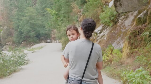 Mother Carrying Her Child While Enjoying a Scenic Walk Along the Othello Tunnels Trail Near Hope, British Columbia