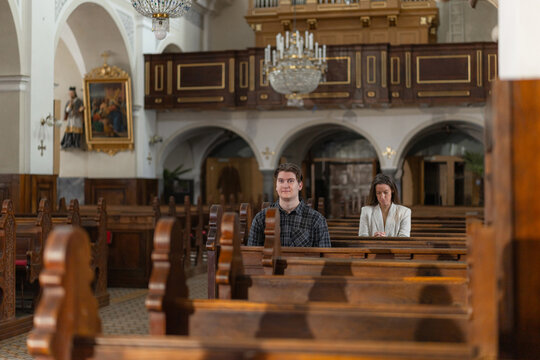 Holy mass while people sit quietly in the church during the ceremony.