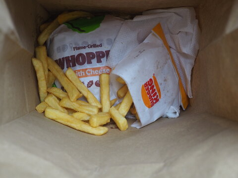 Burger King Takeout Order With Wrapped Whopper Sandwich And French Fries In Paper Bag Photo