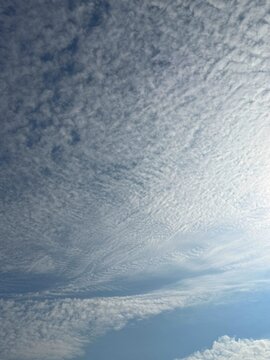Cirrocumulus clouds in blue sky vertical 