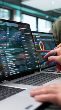 Cybersecurity Analysts Reviewing Risk Findings On Laptop