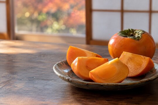 Fresh persimmon wedges on a Japanese autumn table