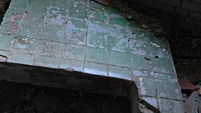 A dirty bench sitting in the middle of a dirty floor