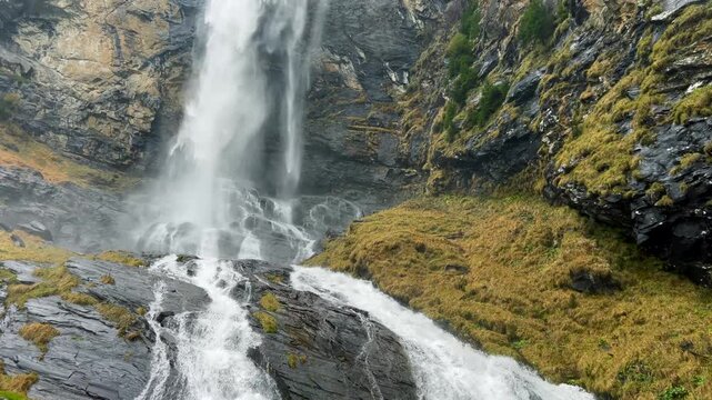 Fallbach mountain waterfall pouring over dark rock. Autumn in Austria.