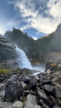 Fallbach mountain waterfall pouring over dark rock. Autumn in Austria.