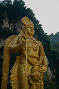 golden lord murugan statue at batu caves in kuala lumpur, malaysia. travel photography
