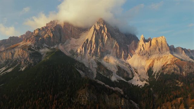 Aerial view of high mountain range covered with clouds in Dolomites, Italy