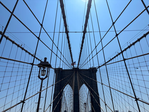 Web of cables of the Brooklyn Bridge converging on the stone tower, New York, United States