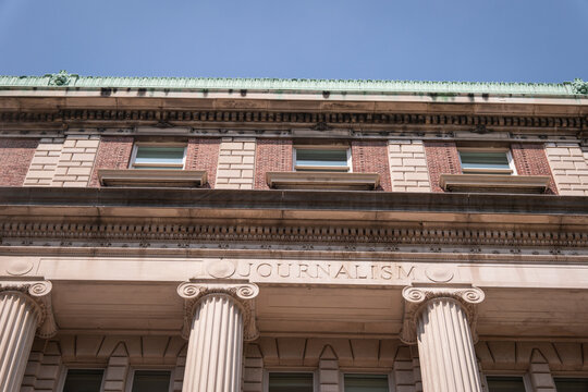 Word Journalism carved on the entablature of a university journalism school building, New York, United States