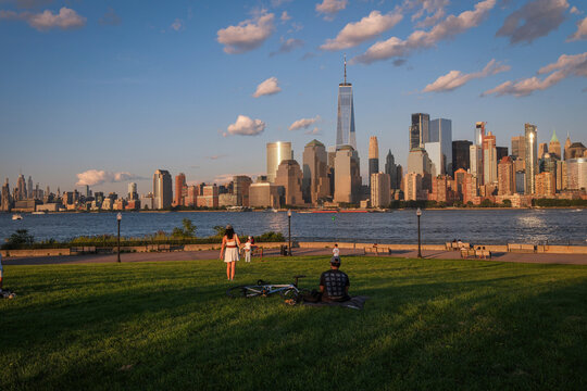 Visitors on the lawn and promenade of Liberty State Park at the end of the day, Jersey City, New Jersey, United States