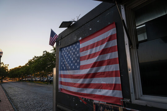 American flags on a kiosk of Liberty State Park at nightfall, Jersey City, New Jersey, United States