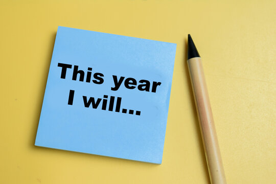 Concept of this year I will write on sticky notes isolated on table.
