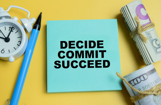 Concept of decide, commit, succeed write on sticky notes isolated on table.