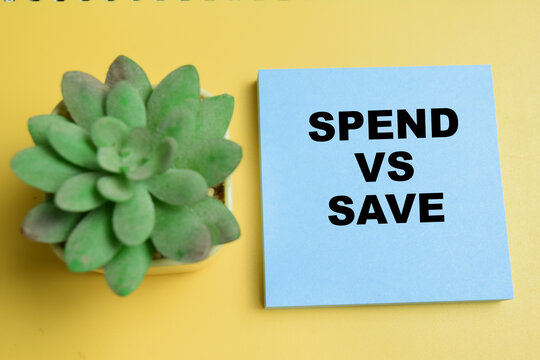 Concept of spend vs save write on sticky notes isolated on table.
