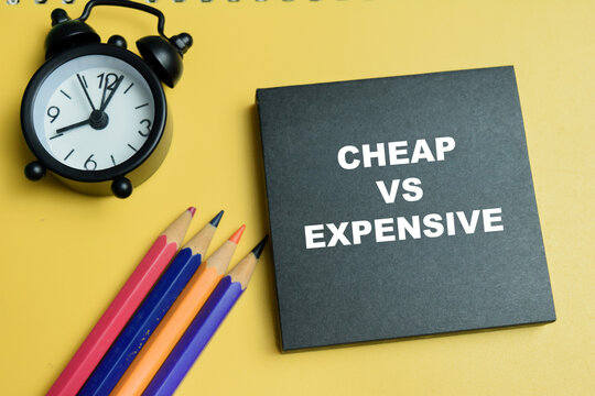 Concept of cheap vs expensive write on sticky notes isolated on table.