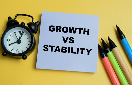 Concept of growth vs stability write on sticky notes isolated on table.