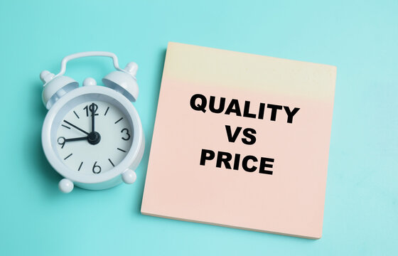 Concept of quality vs price write on sticky notes isolated on table.