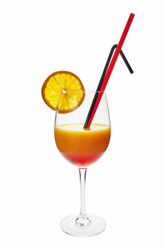 Tequila sunrise cocktail in glass with orange slice and straws