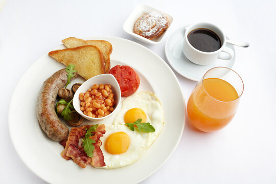 Full english breakfast with eggs, bacon, sausage, beans, toast