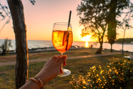 Orange aperitif at sunset by the Adriatic Sea in Umag Croatia