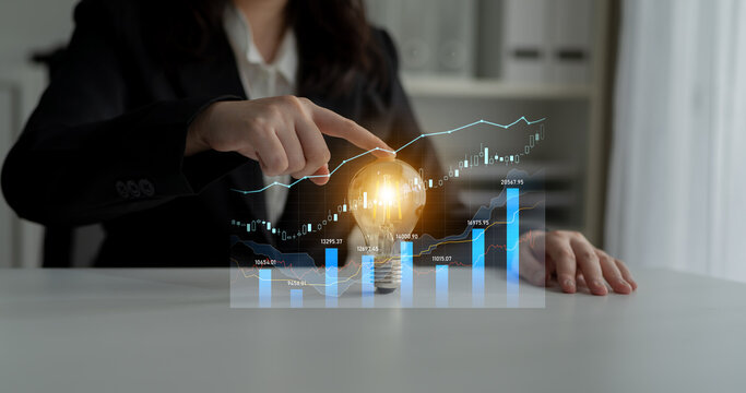 A business professional examines data insights represented by a glowing light bulb, symbolizing creativity and innovation, in a modern office environment. Scalp
