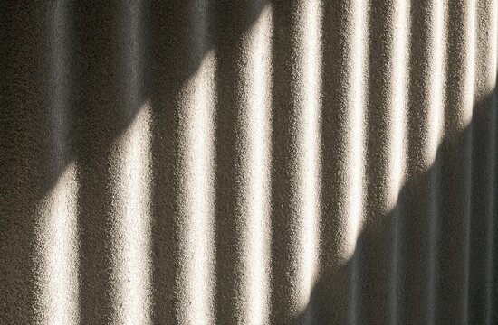 Textured surface with parallel ridges cast in dramatic light and shadow