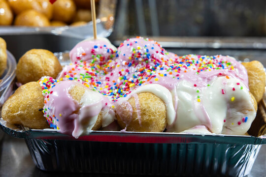 Traditional Greek Loukoumades with White Chocolate and Banana at a Christmas Market