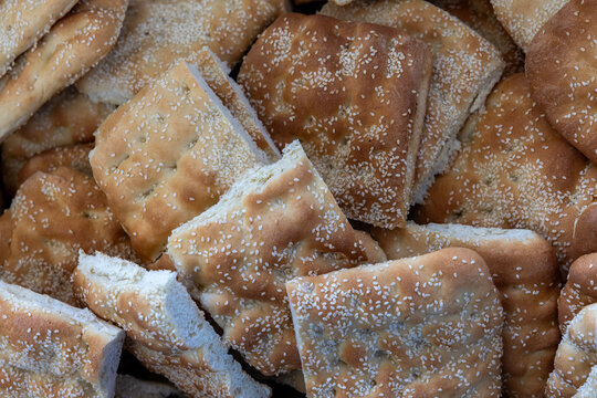 Traditional Greek Lagana Bread Topped with Sesame Seeds at a Local Bakery