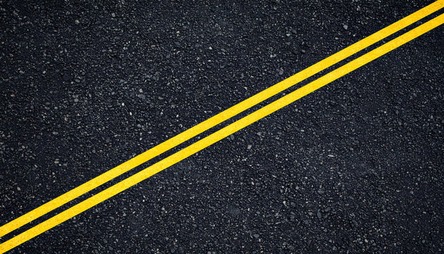 Detailed close-up shot of dark black asphalt road surface with sharp yellow double lines running diagonally across. Perfect textured background for transportation and travel concepts.
