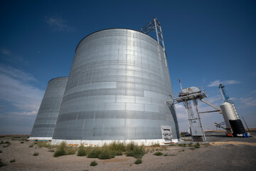 Ultrawide view of cluster of grain bins at grain elevator site © lvonbiela