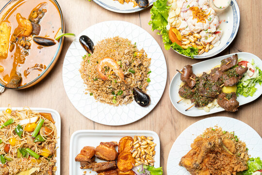 Peruvian food dishes on wooden table overhead view
