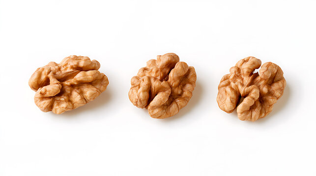 Three shelled English walnut kernels or Juglans regia arranged horizontally on a pure clean white background for a minimalist product shot