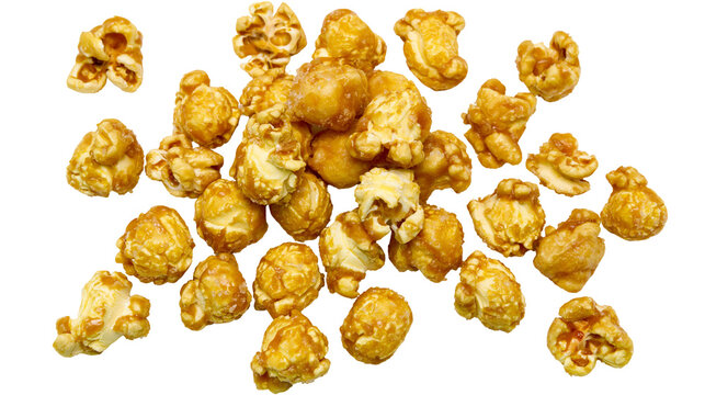 Isolated delicious sweet golden caramel coated popcorn pieces scattered for a tasty snack