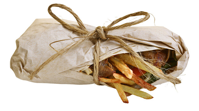 Isolated flavorful fast food kebab wrap with french fries in rustic paper package