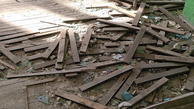 A pile of broken wood debris sitting on the ground