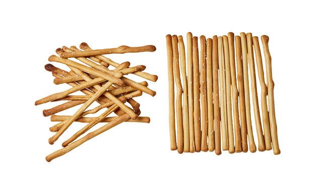 Isolated crispy golden baked breadsticks piled and neatly arranged, a delicious salty snack